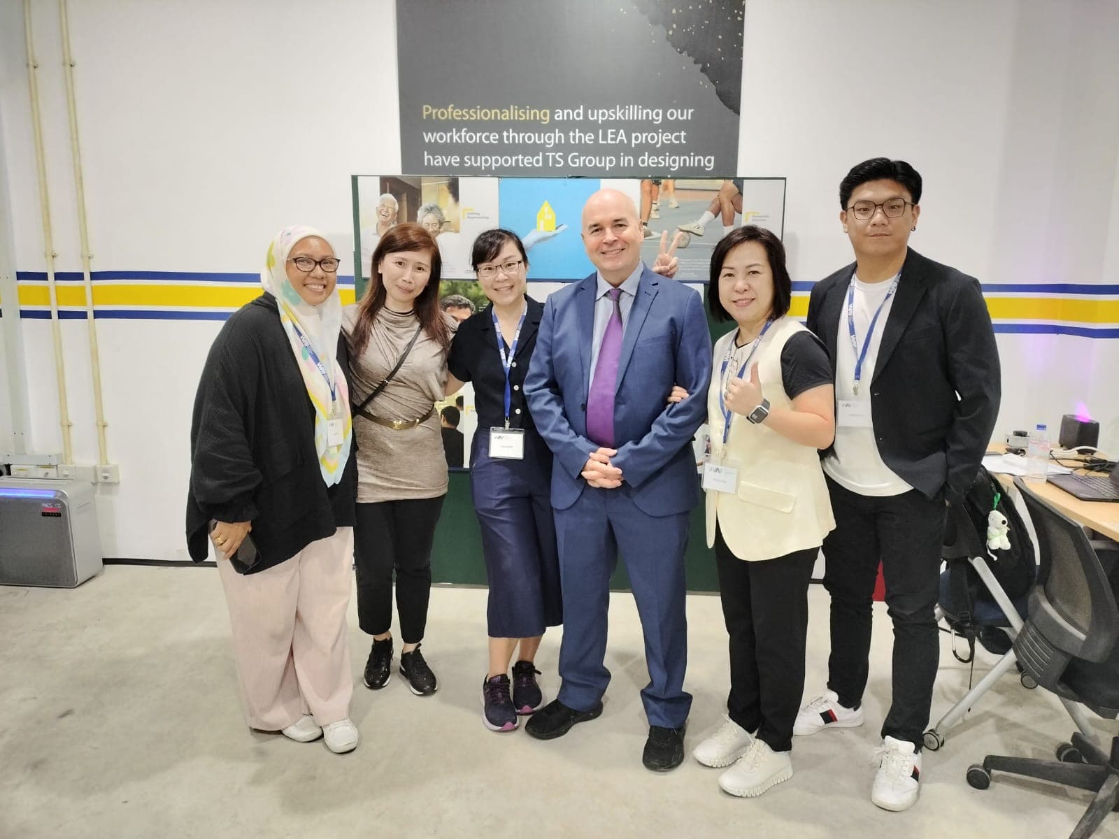 William standing with clients taking a picture